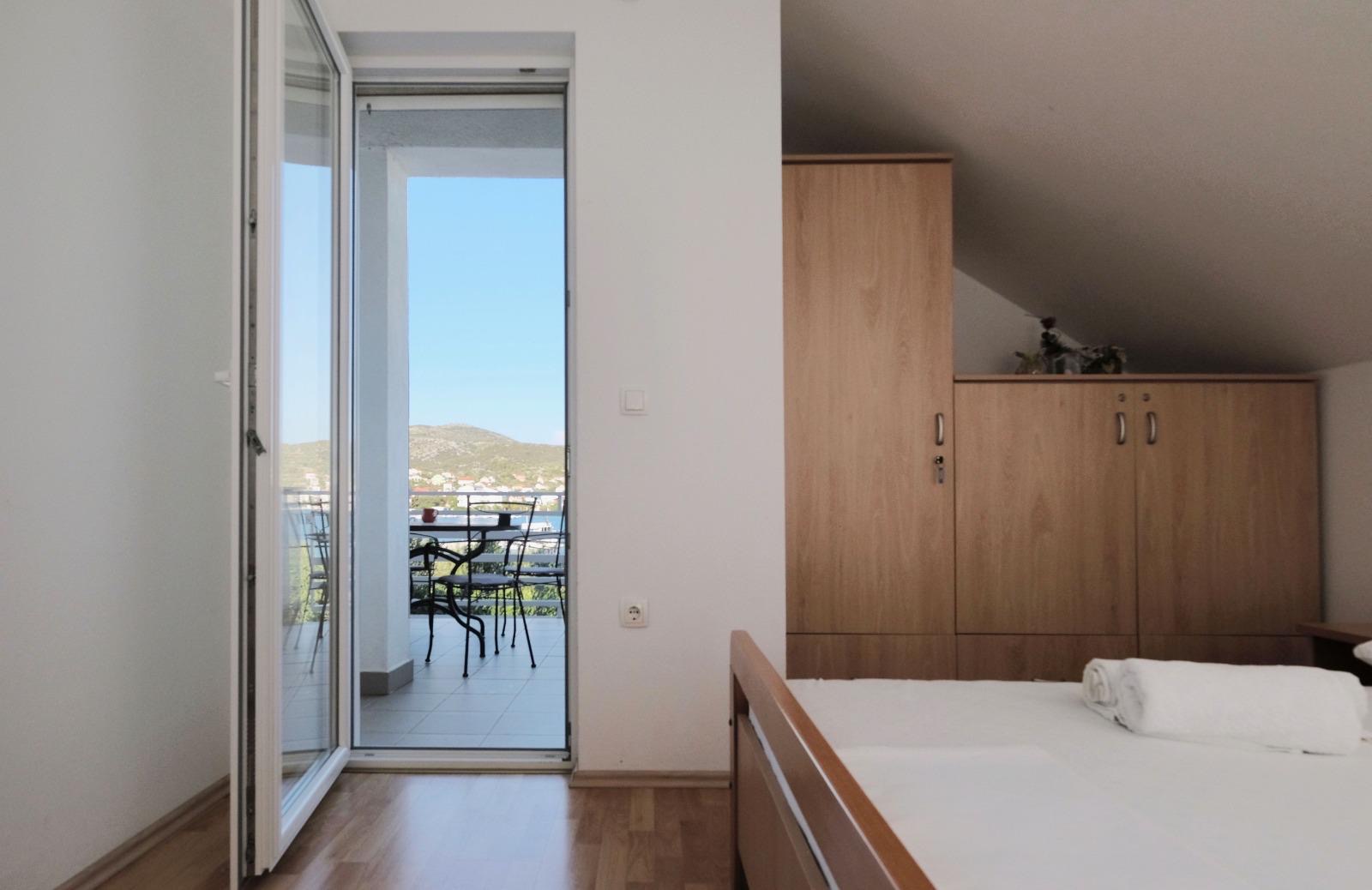 Bedroom with open balcony door, view to Adriatic bay